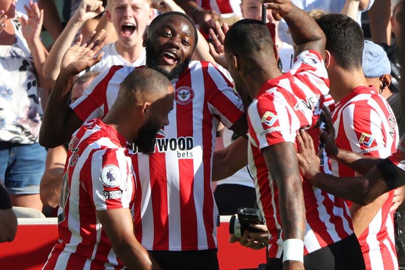 Josh Dasilva, second left, celebrates with team-mates after scoring the opening goal. AP