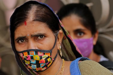 A woman wears a protective face mask in Bangalore, India. EPA / JAGADEESH NV