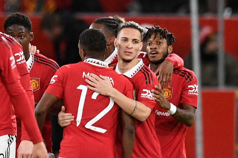 United midfielder Antony celebrates with teammates after scoring the opening goal. AFP