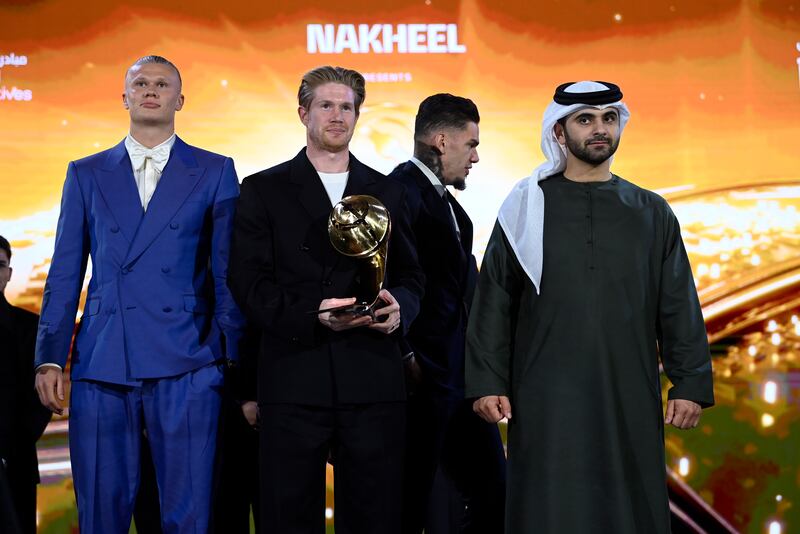 From left, Manchester City's Erling Haaland, Kevin De Bruyne and Ederson receive the Best Men’s Club award. AP