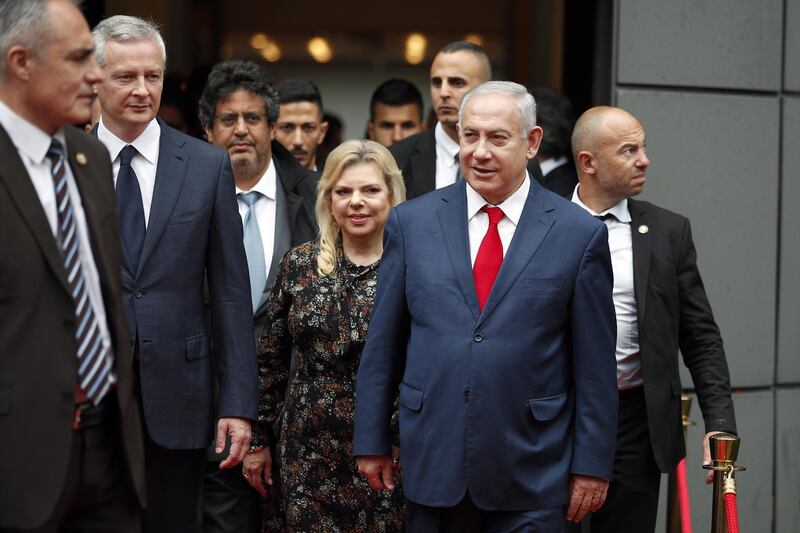 Israel's Prime Minister Benjamin Netanyahu and his wife Sara Netanyahu walk out after their meeting with French Finance Minister Bruno Le Maire, second left, at Bercy Economy Ministry, in Paris, Wednesday, June 6, 2018. Netanyahu met French Finance Minister Bruno Le Maire, who is pushing to maintain European trade with Iran allowed under the 2015 deal curbing Iranian nuclear activities.(AP Photo/Francois Mori)