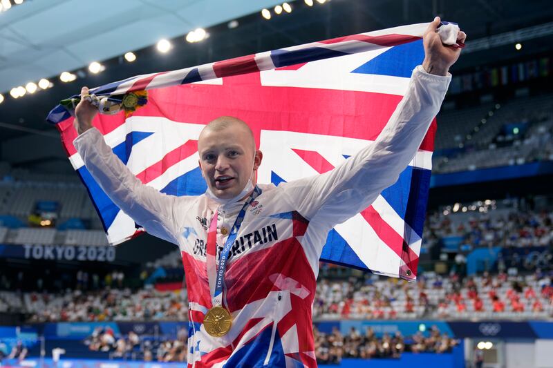 Adam Peaty of Britain celebrates after winning the final of the men's 100-meter breaststroke at the 2020 Summer Olympics.