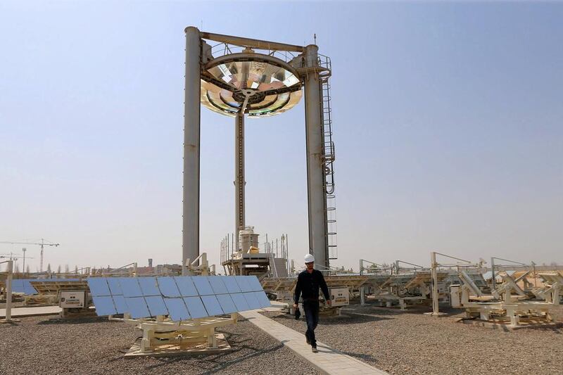 An employee walks at a solar plant in Masdar City. Another GCC country besides the UAE will go solar, says Robin Mills, the head of consulting at Manaar Energy. Karim Sahib / AFP