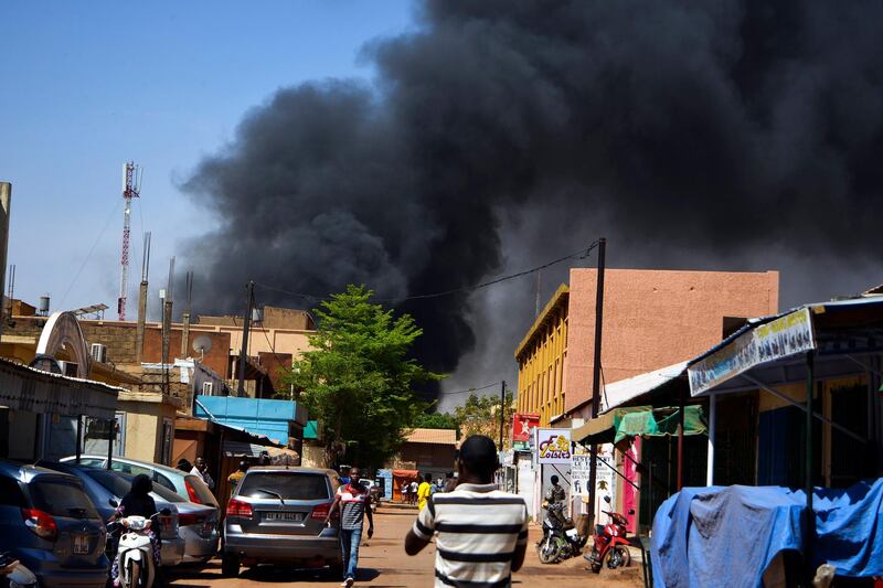 epa06575783 Smoke rises in the streets amidst a suspected terrorist attack in the capital Ouagadougou, Burkina Faso, 02 March 2018. According to reports at least 28 people have been killed in the attacks on the French embassy and miltary HQ in Ouagadougou. It is yet unclear who stands behind the attacks.  EPA/STR