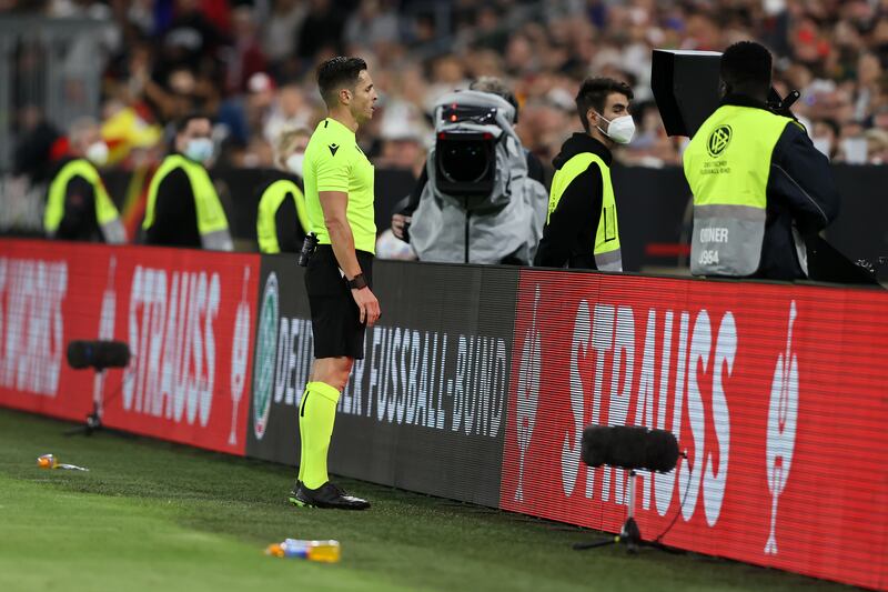 Referee Carlos del Cerro Grande checks the VAR screen before awarding England a penalty. Getty