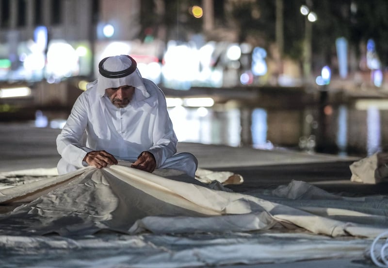 Abu Dhabi, United Arab Emirates, May 18, 2019. –  ‘Ramadan at Al Hosn’, which aims to revive the authentic traditions of Ramadan by recalling the memories rooted in our past, when the people of Abu Dhabi gathered at Qasr Al Hosn to celebrate the holy month. --  Emirati fisherman  sews a fishing boat sail.
Victor Besa/The National
Section:  NA
Reporter: