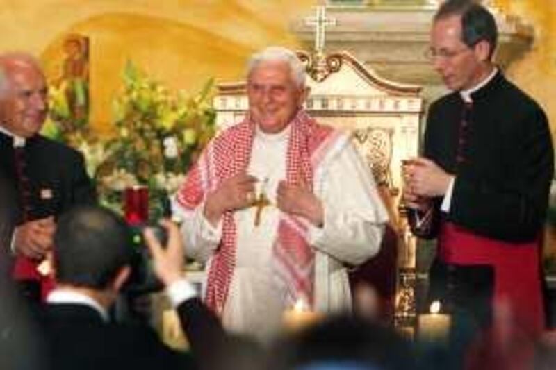 Pope Benedict XVI wears a traditional Jordanian "Keffeyeh" that was presented to him during his visit to the Lady of Peace Church in Amman, Jordan Friday, May 8, 2009. Pope Benedict XVI expressed deep respect for Islam Friday and said he hopes the Catholic Church can play a role in Mideast peace as he began his first trip to the region, where he hopes to improve frayed ties with Muslims. (AP Photo/Nasser Nasser) *** Local Caption ***  NN115_Mideast_Jordan_Pope_.jpg