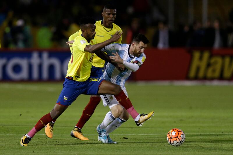 Lionel Messi, right, fights for the ball against Ecuador's Jefferson Orejuela. Dolores Ochoa / AP Photo