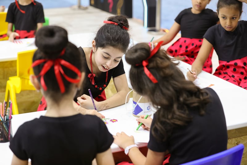 Students from the Victoria English school, Sharjah, draw  pictures at a festival workshop. Photo: Chris Whiteoak / The National