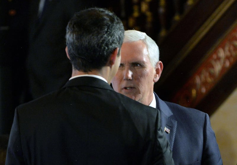 TOPSHOT - US Vice President Mike Pence (R) and Venezuelan opposition leader and self-declared acting president Juan Guaido (backwards), take part in a meeting with Foreign Ministers of the Lima Group at Colombia's Foreign Affairs Ministry in Bogota, on February 25, 2019. US Vice President Mike Pence passed on a message from Donald Trump to Venezuela's opposition leader Juan Guaido on Monday, telling him "we are with you 100 percent." Pence and Guaido met in Colombia's capital during a meeting of regional allies to discuss their next move in response to the crisis in Venezuela. / AFP / Diana Sanchez
