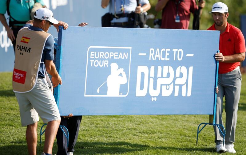 Jon Rahm (R) of Spain with his caddie carry a banner during the final round of DP World Tour Championship European Tour Golf tournament 2018 at Jumeirah Golf Estates in Dubai, United Arab Emirates.  EPA