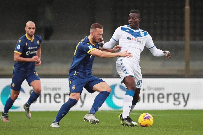 Hellas Verona's Amir Rrahmani in action against Brescia's Mario Balotelli. EPA