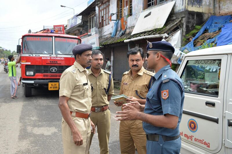 Rescue officials belonging to state and central authorities discuss their rescue plans for flood victims at Mala village in Thrissur District, Kerala. AFP