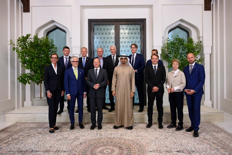 Sheikh Mohamed and Olaf Scholz pose for a photograph with the German Economic delegation, after a meeting at Al Shati Palace. Photo: UAE Presidential Court