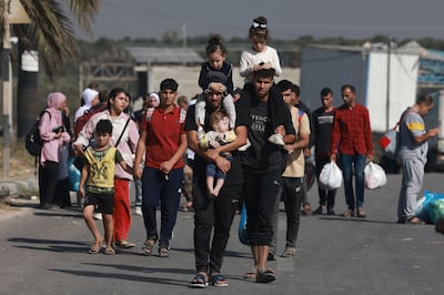 Palestinians fleeing Gaza City towards the southern areas walk on a road on November 8, 2023. AFP