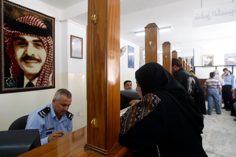 Jordanians of Palestinian origin rectify their status by renewing permits that recognise them as nationals in the West Bank, at the related police department in Amman, Jordan on July 28, 2009. (Salah Malkawi/ The National)