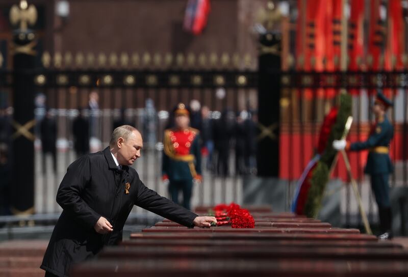 Russian President Vladimir Putin lays flowers at the Memorial to Hero Cities at the Tomb of the Unknown Soldier after the Victory Day military parade in Moscow.  EPA