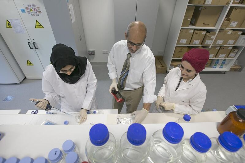 Prof. Dr. Amr Amin, researches cancer healing properties of saffron with his graduate students Ala’a Al Hrout and Badriya Baig in United Arab Emirates University. Mona Al Marzooqi / The National 