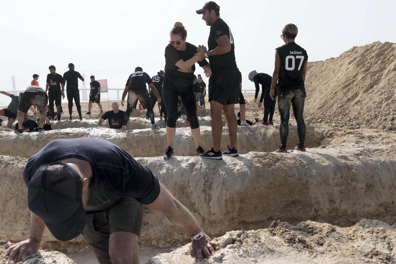 ABU DHABI, UNITED ARAB EMIRATES. 11 OCTOBER 2019. The Tough Mudder sports event held on Hudayriat Island in Abu Dhabi. The main Tough Mudder event challenged dedicated and amateur athletes with a 5km course designed to get participants moving over obstacles and along a dedicated route engineered to build team spirit. (Photo: Antonie Robertson/The National) Journalist: None. Section: National.
