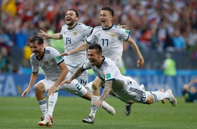 FILE - In this Sunday, July 1, 2018 file photo Russia's Fyodor Smolov, right, dives as he celebrates with teammates after Russia defeated Spain in a penalty shoot out during the round of 16 match between Spain and Russia at the 2018 soccer World Cup at the Luzhniki Stadium in Moscow, Russia. (AP Photo/Manu Fernandez)