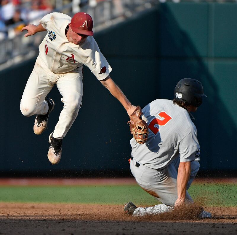 Oregon State's Cadyn Grenier steals second base under the tag of Arkansas' Jax Biggers during the third inning in Game 3 of the NCAA College World Series baseball finals in Omaha. AP Photo / Ted Kirk