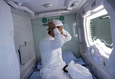 epa06955419 A hajj pilgrim adjusts his headgear in his capsule room in Mecca, Saudi Arabia, 16 August 2018 (issued 18 August 2018). Hajj season pilgrims will be able to try out the latest mobile hotel capsules - sleeping units that offer hotel room services and facilities in the smallest possible space, Hadiyah, the Hajji and Muâ€™tamerâ€™s Gift Charitable Association has announced.  EPA/SEDAT SUNA