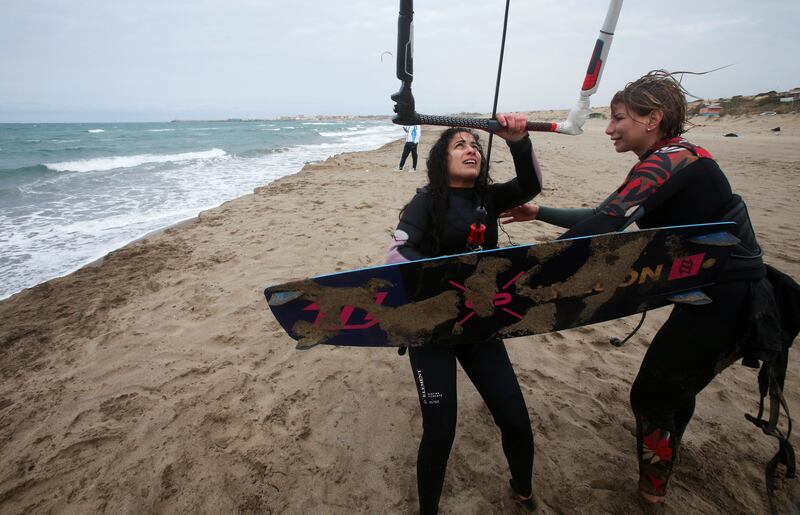 Pharmaceutical employee Karima Aithami, right, helps another woman set up her rig to kitesurf at Le Grand Bleu tourist complex in Boumerdes, Algeria. All photos: Reuters