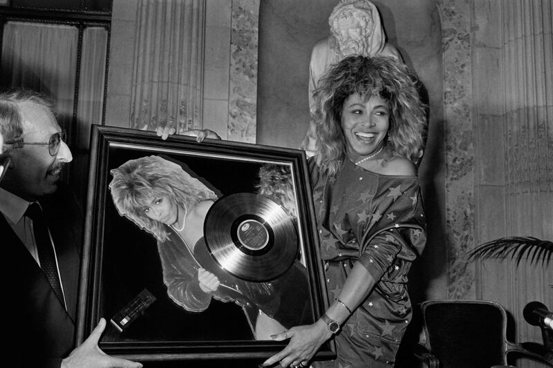Turner receives the Golden Record Award from Pathe Marconi chairman Guy Deluz, left, in 1986, in Paris. AFP