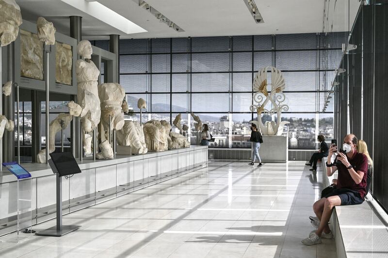 Visitors walk in the Parthenon Gallery of the Acropolis Museum in Athens, devoted to the sculptures of the Temple of Parthenon. AFP