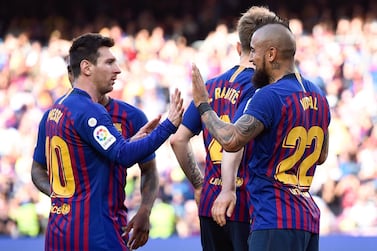 Barcelona's Chilean midfielder Arturo Vidal celebrates with Barcelona's Argentinian forward Lionel Messi (L) after scoring a goal during the Spanish League football match between Barcelona and Getafe at the Camp Nou Stadium in Barcelona on May 12, 2019. / AFP / Josep LAGO