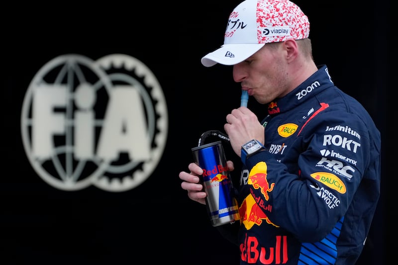 Red Bull driver Max Verstappen takes a drink at the Suzuka Circuit after claiming pole position for the Japanese Formula One Grand Prix. AP