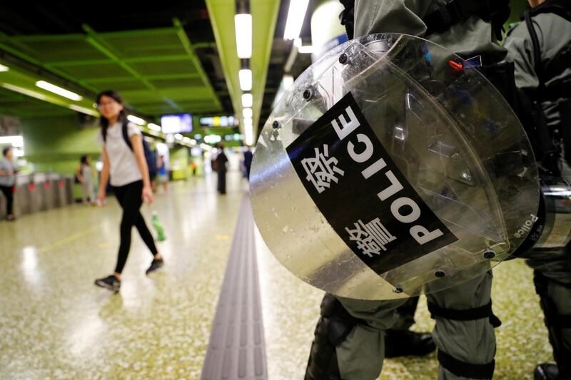A riot police holds his shield at a Mass Transit Railway (MTR) station in Hong Kong, China. Reuters