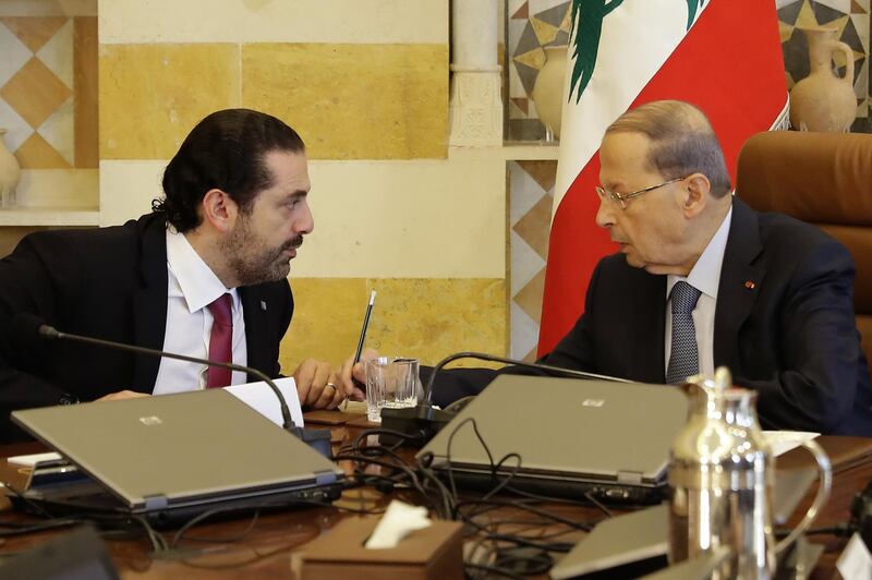 Lebanese President Michel Aoun (R) and Prime Minister Saad Hariri attend a cabinet meeting at the presidential palace of Baabda, east of the capital Beirut, on December 5, 2017. (Photo by JOSEPH EID / AFP)