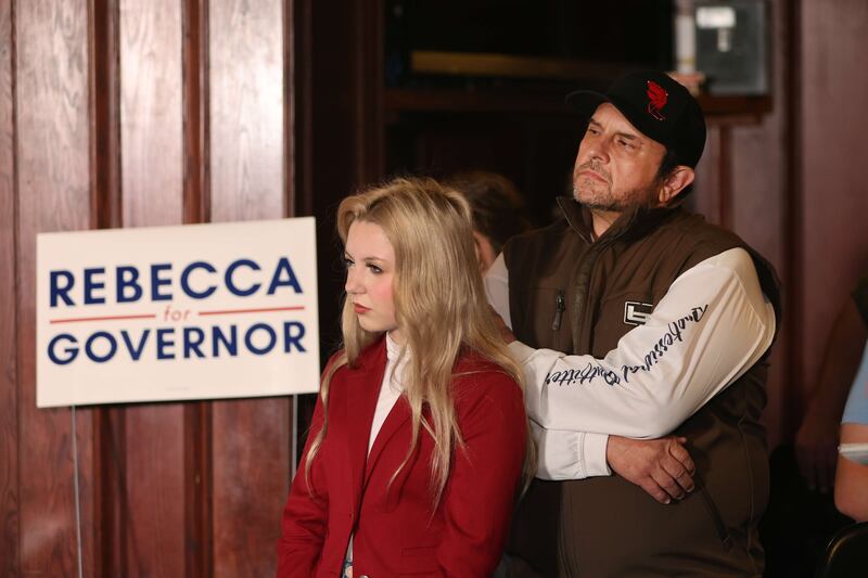 Joel Kleefisch and his daughter Ella listen as his wife Rebecca addresses a campaign event in Madison, Wisconsin. Getty Images / AFP
