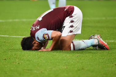 Aston Villa's Trezeguet kisses the pitch after the victory over Arsenal. AP