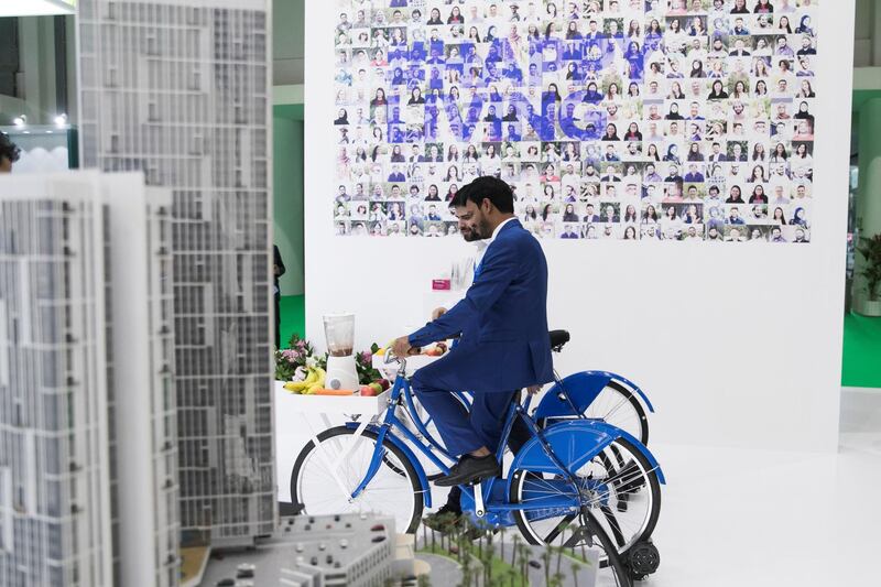 ABU DHABI, UNITED ARAB EMIRATES - April 16 2019.

A man cycles and powers a juice mixture at Tamouh's booth at Cityscape Abu Dhabi 2019.

(Photo by Reem Mohammed/The National)

Reporter: Gillian Duncan
Section: NA + BZ