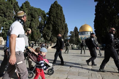 Israeli settlers, protected by the Israeli security forces, walk through Al Aqsa Mosque compound in Jerusalem  yesterday morning. AFP