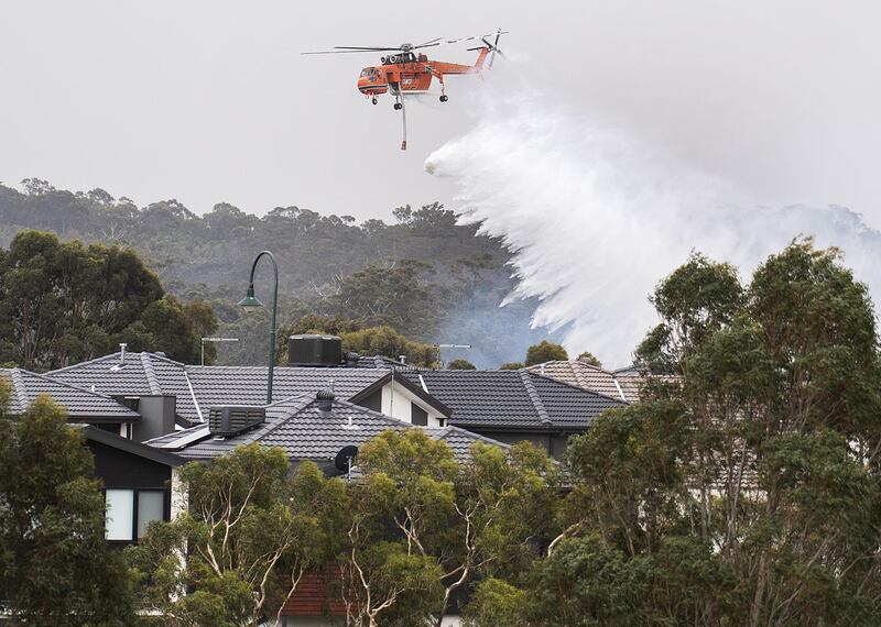 A Skycrane drops water on a bushfire in Bundoora, Melbourne, Australia. EPA