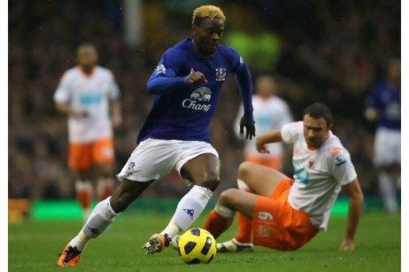 Louis Saha leaves Blackpool's Ian Evatt sprawling at Goodison Park last Saturday. He netted four goals in a 5-3 victory.