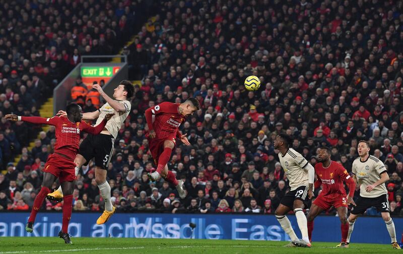 Liverpool forwartd Roberto Firmino winners a header. AFP