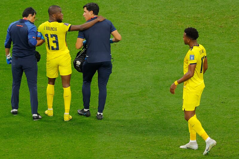 Enner Valencia is helped by medical assistants after an injury scare. AFP