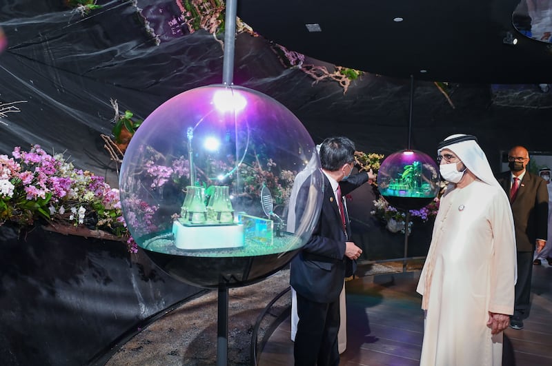 Sheikh Mohammed views an exhibit sphere at the Singapore pavilion.