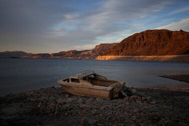 FILE - A formerly sunken boat sits high and dry along the shoreline of Lake Mead at the Lake Mead National Recreation Area, on May 10, 2022, near Boulder City, Nev.  Federal officials on Tuesday, Aug.  16, 2022, are expected to announce water cuts that would further reduce how much Colorado River water some users in the seven U. S.  states reliant on the river and Mexico receive.  (AP Photo / John Locher, File)