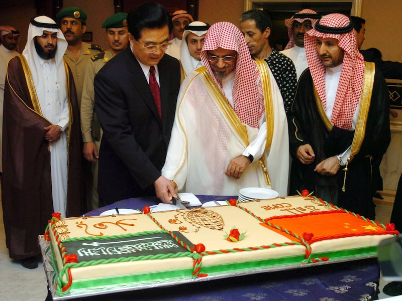 Saudi Shura Council president Sheikh Saleh Al Hameid, centre, and Chinese President Hu Jintao cut a cake during a welcoming ceremony in Riyadh, Saudi Arabia, in April 2006.