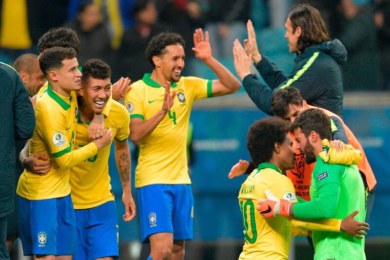 Brazil's players celebrate after defeating Paraguay in their penalty shoot-out. AFP
