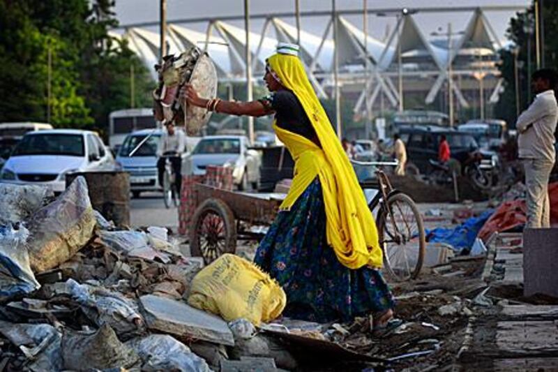 An Indian worker at an unfinished construction site next to the lawn bowling venue outside Jawaharlal Nehru Stadium, the main venue for the Commonwealth Games. Kevin Frayer/ AP Photo