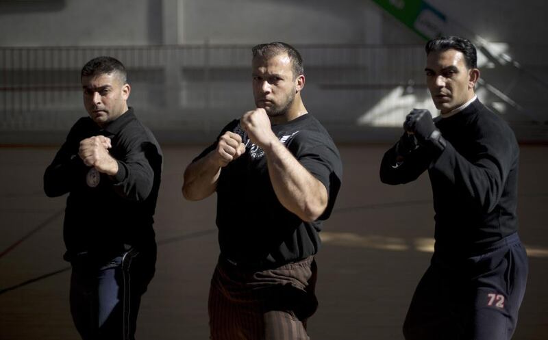 Inside one of Gaza City’s handful of sports centres, dozens of sweaty men — young and not so young — are put through their paces in various martial arts and other exercises to stay in shape for the job.