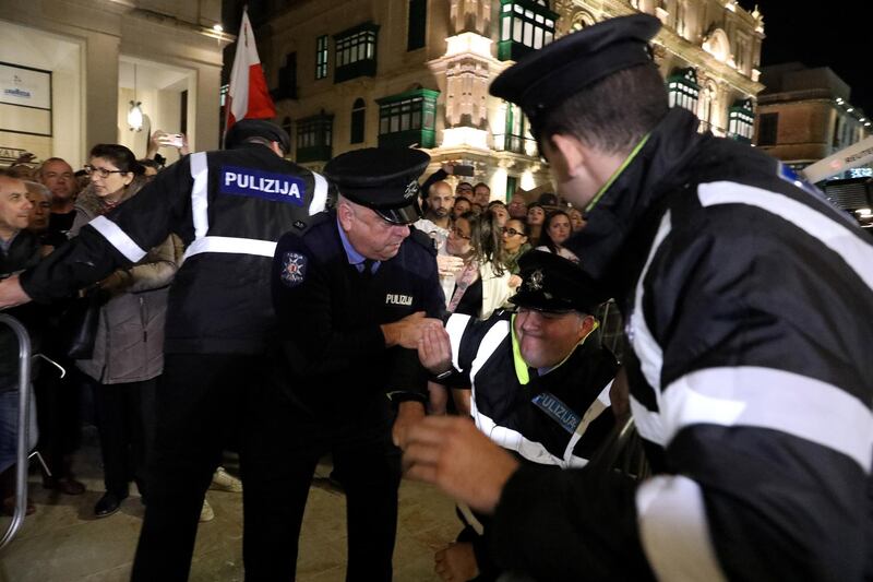A policeman was injured as demonstrators protest outside Malta's House of Parliament. EPA