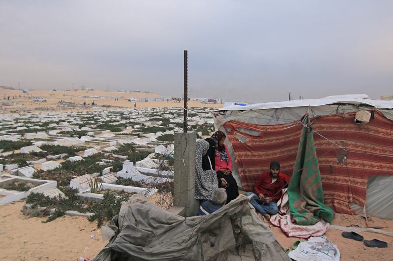 Displaced Palestinians in a makeshift camp beside the Tal Al Sultan cemetery, west of Rafah. Bloomberg
