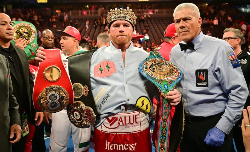 Saul Alvarez poses with his belts and crown after defeating Gennady Golovkin to retain his undisputed super-middleweight crown at T-Mobile Arena in Las Vegas, Nevada, September 17, 2022.  AFP
